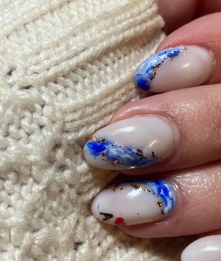 Elegant blue and white nail art from SassyGoose, Bloemfontein, Free State, ZA, showcasing creativity and style.
