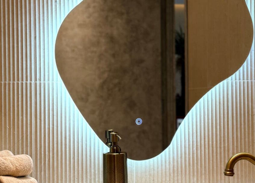 Elegant curved mirror at Look & Love Beauty Salon, Dubai, Dubai, AE, with modern amenities in chic setting.