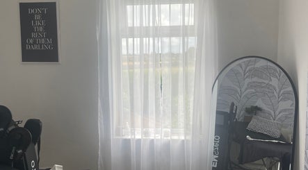 Bright therapy room at Shape & Sculpt with Grace, Liverpool, England, GB, with sheer curtains and modern decor.
