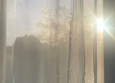 Gentle sunlight filters through curtains at Shape & Sculpt with Grace, Liverpool, England, GB.