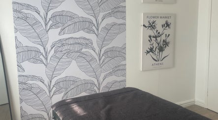 Stylish therapy room at Shape & Sculpt with Grace, Liverpool, England, GB, featuring botanical artwork walls.