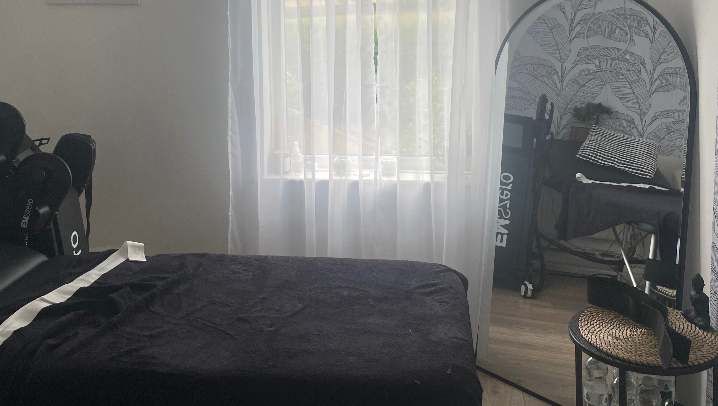 Relaxing spa room at Shape & Sculpt with Grace, Liverpool, England, GB, featuring massage bed and decor.