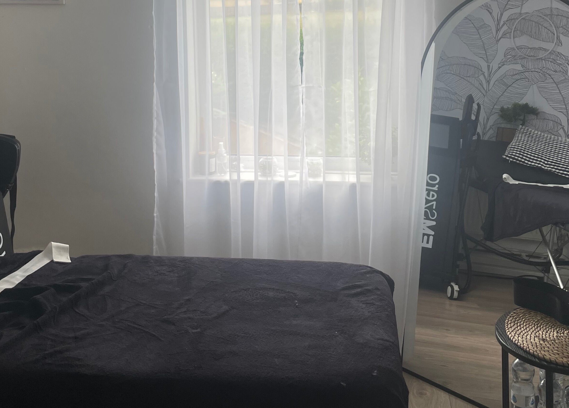 Relaxing spa room at Shape & Sculpt with Grace, Liverpool, England, GB, featuring massage bed and decor.