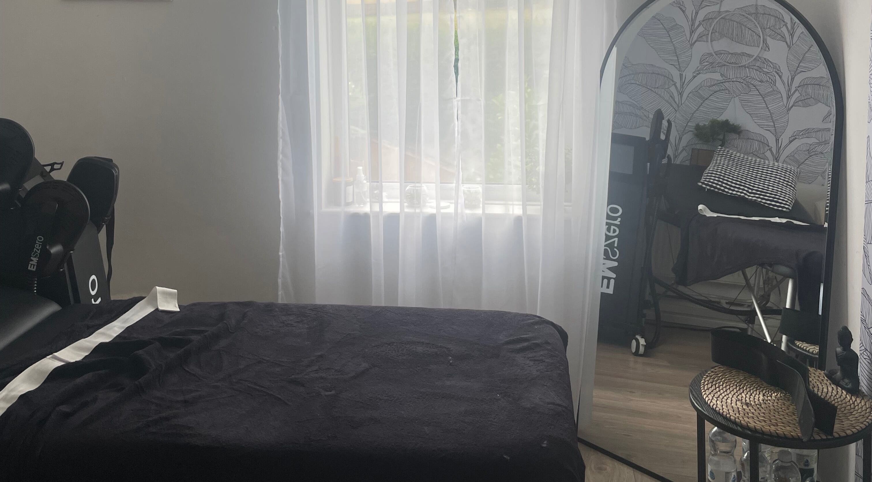 Relaxing spa room at Shape & Sculpt with Grace, Liverpool, England, GB, featuring massage bed and decor.