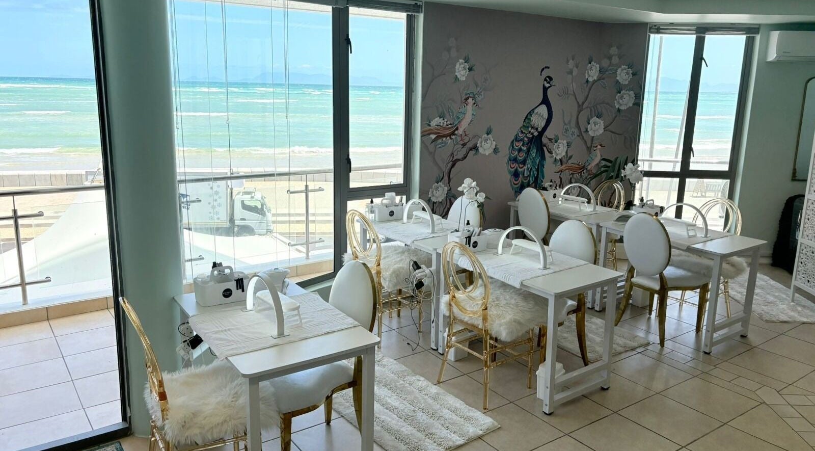 Elegant mani-pedi setup at Opulence Strand in Cape Town, offering ocean vistas and luxury ambiance.