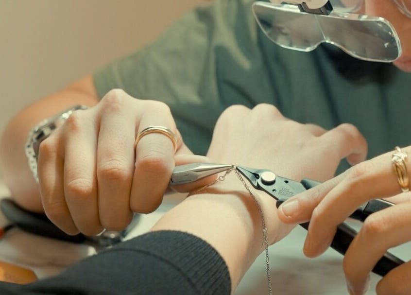 Close-up of jewelry crafting at Tish Lyon, London, England, GB, showcasing detailed handwork.