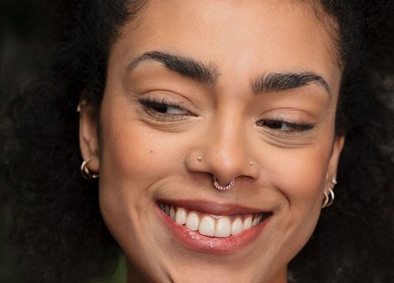 Close-up of a smiling person displaying a radiant facial glow at Tish Lyon in London, England, GB.