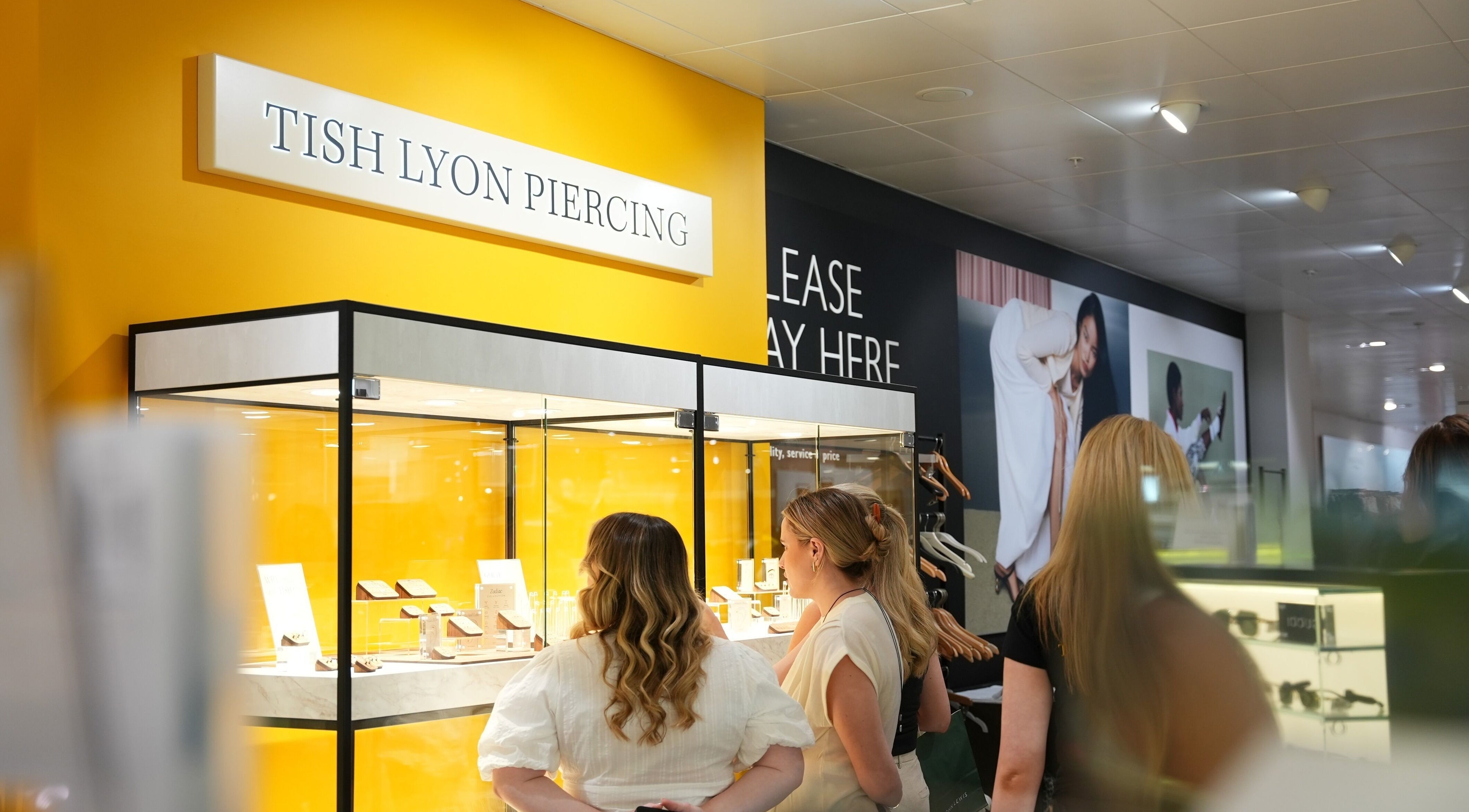 Customers admire jewelry at Tish Lyon Luxury Piercing & Jewellery Studio - Liverpool, England, GB.