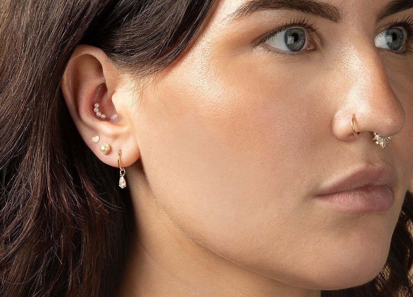 Close-up of ear and nose piercings at Tish Lyon Luxury Piercing & Jewellery Studio - Bluewater, Dartford, England, GB.