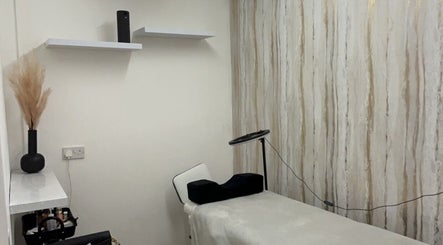 Cozy beauty treatment room at pblashess in Corby, England, GB with a treatment bed and elegant decor.