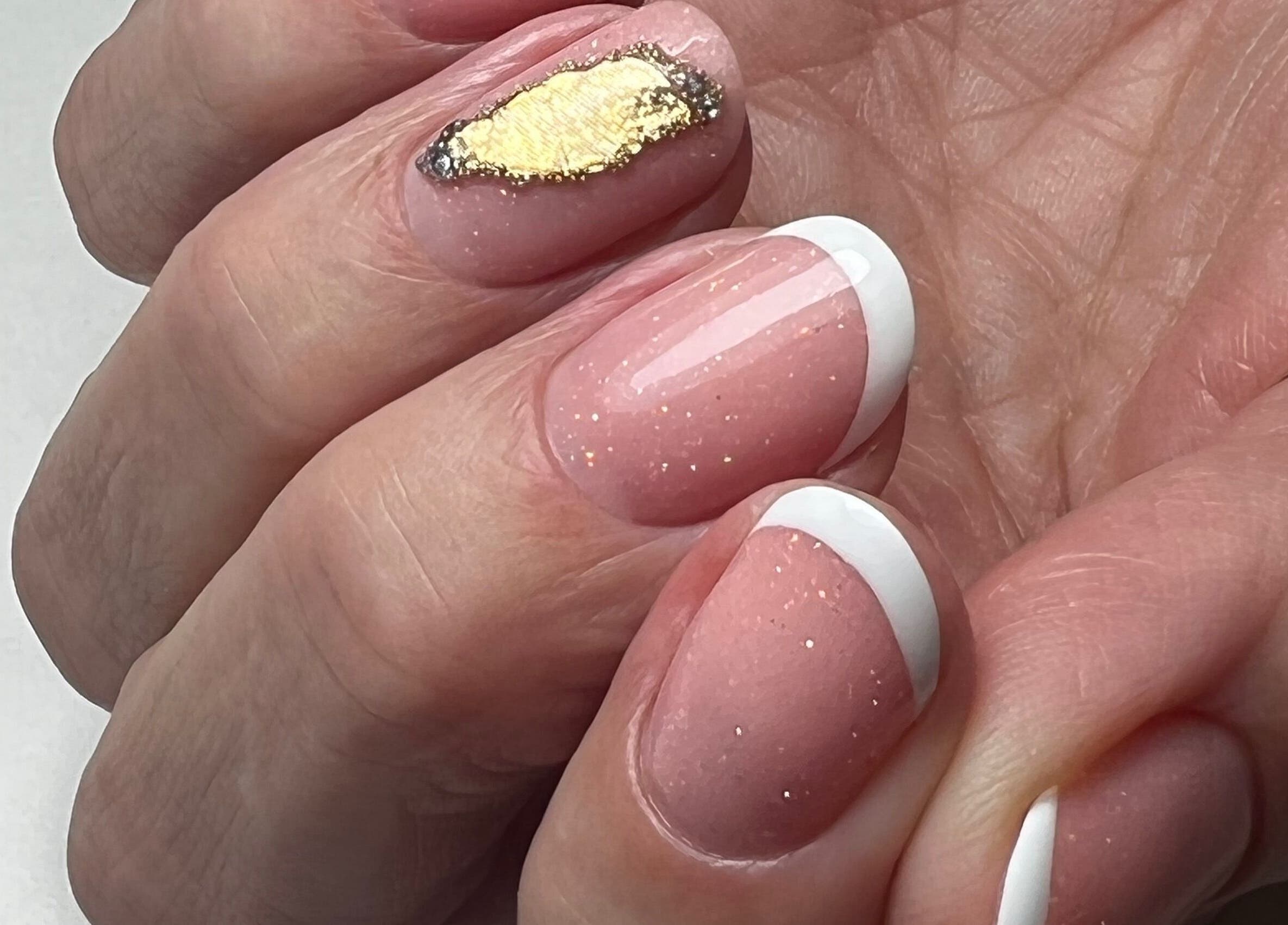 Stylish French manicure with gold accent nail at Livys Beauty Room, Norwich, England, GB.