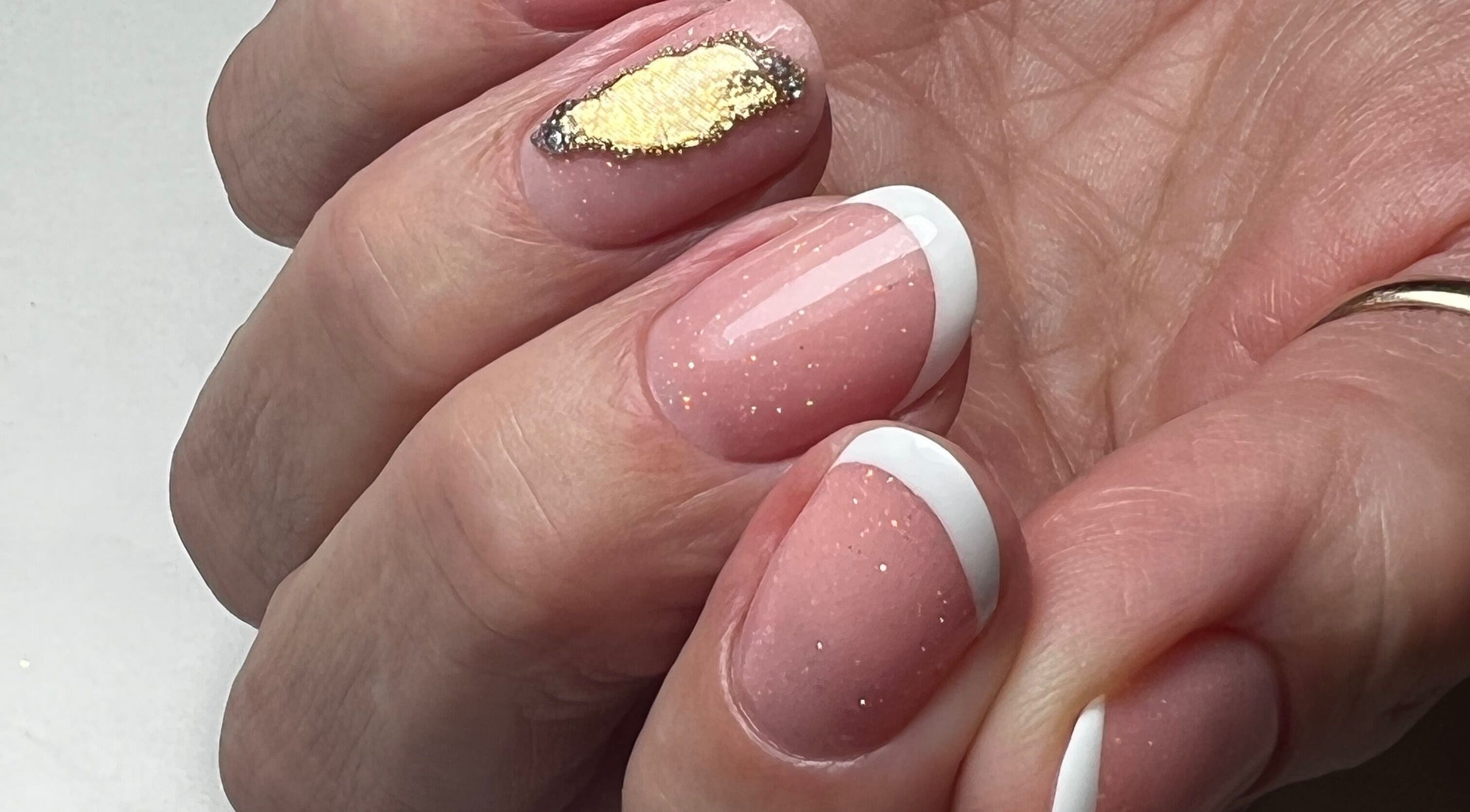 Stylish French manicure with gold accent nail at Livys Beauty Room, Norwich, England, GB.