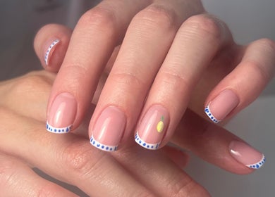 Stylish nail art at Livys Beauty Room, Norwich, England, GB. Features elegant blue and white pattern.