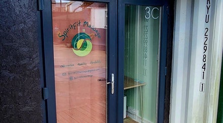 Entrance to Spiritfit Massage, Penryn, England, GB, showcasing welcoming glass door and vibrant logo.