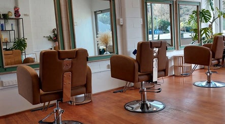 Sleek salon chairs at Botanical Blade hair studio in Dunedin, Otago Region, NZ offer a stylish, modern setting.