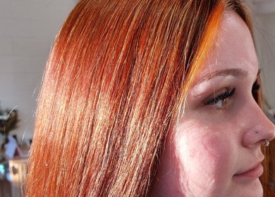 Vibrant red hair at Botanical Blade hair studio, Dunedin, Otago Region, NZ shines in natural light.