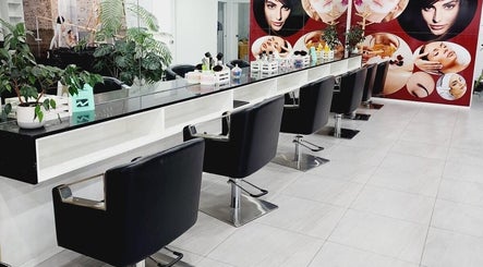 Modern salon interior at Hairmakeover Huntly, Huntly, Waikato Region, NZ, showcasing sleek black styling chairs.