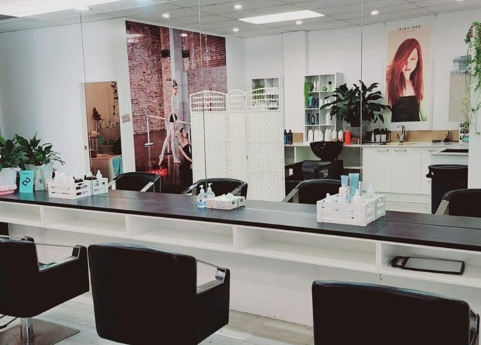 Interior of Hairmakeover Clendon in Auckland, Auckland, NZ, featuring sleek styling chairs and modern decor.