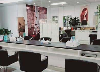 Modern interior of Hairmakeover Manurewa in Auckland, Auckland, NZ with mirrors and styling chairs.