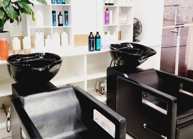 Modern wash station at Hairmakeover Manurewa in Auckland, Auckland, NZ, showcasing sleek black chairs and products.