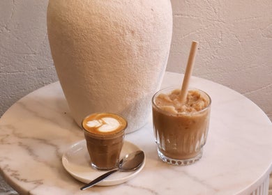 Artisan coffee beverages on marble table at Hearth Hair, Wollongong, New South Wales, AU.