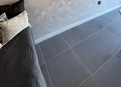 Modern seating area at Elegant Touch Beauty in Gqeberha, Eastern Cape, ZA, featuring chic pillows and flooring.