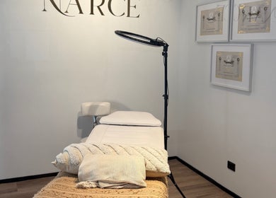 Relaxing spa room at Narce in West End, Queensland, AU with a massage table and warm lighting.