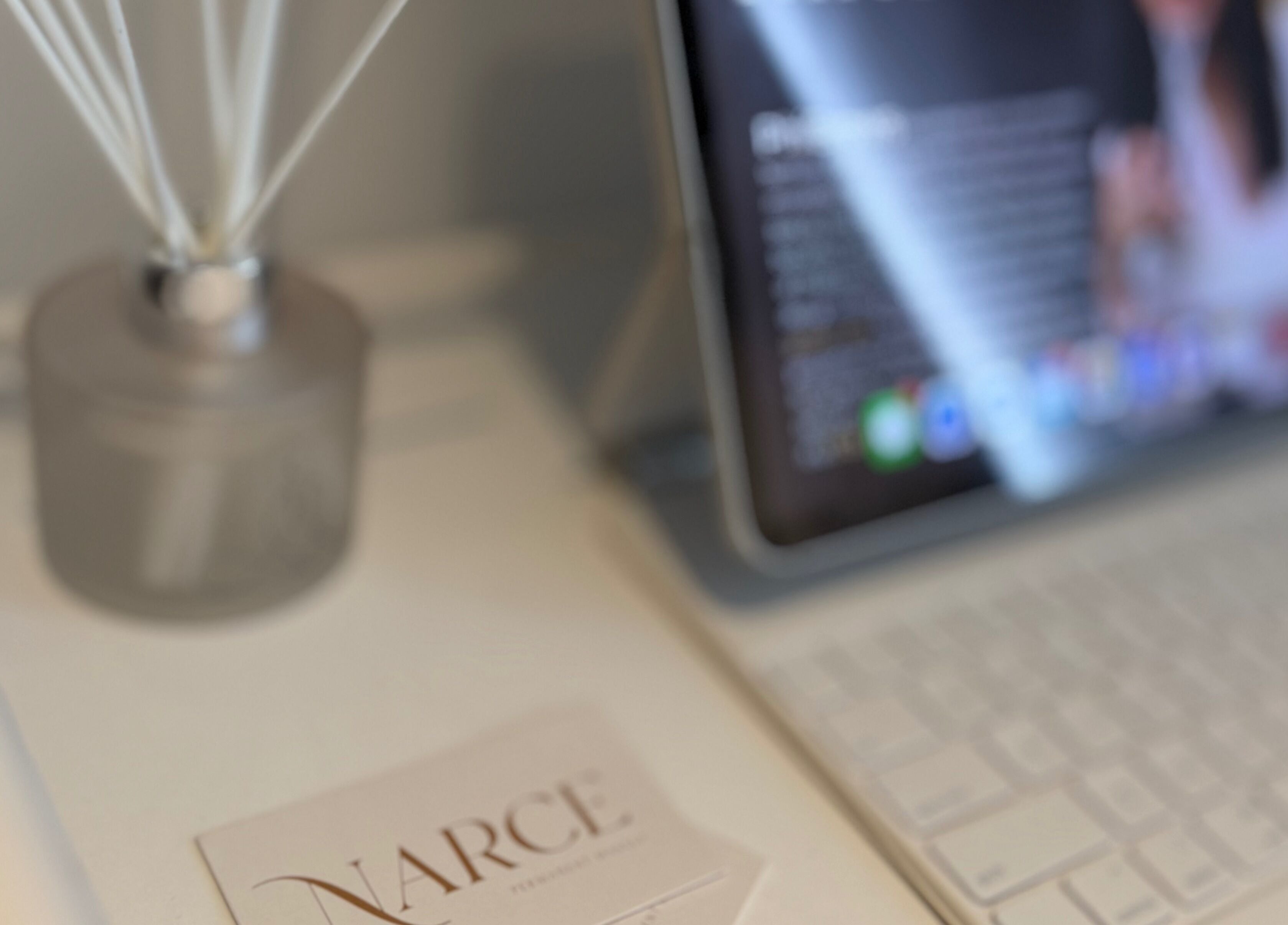 Elegant display at Narce, West End, Queensland, AU, featuring a diffuser and tablet on a tranquil desk.