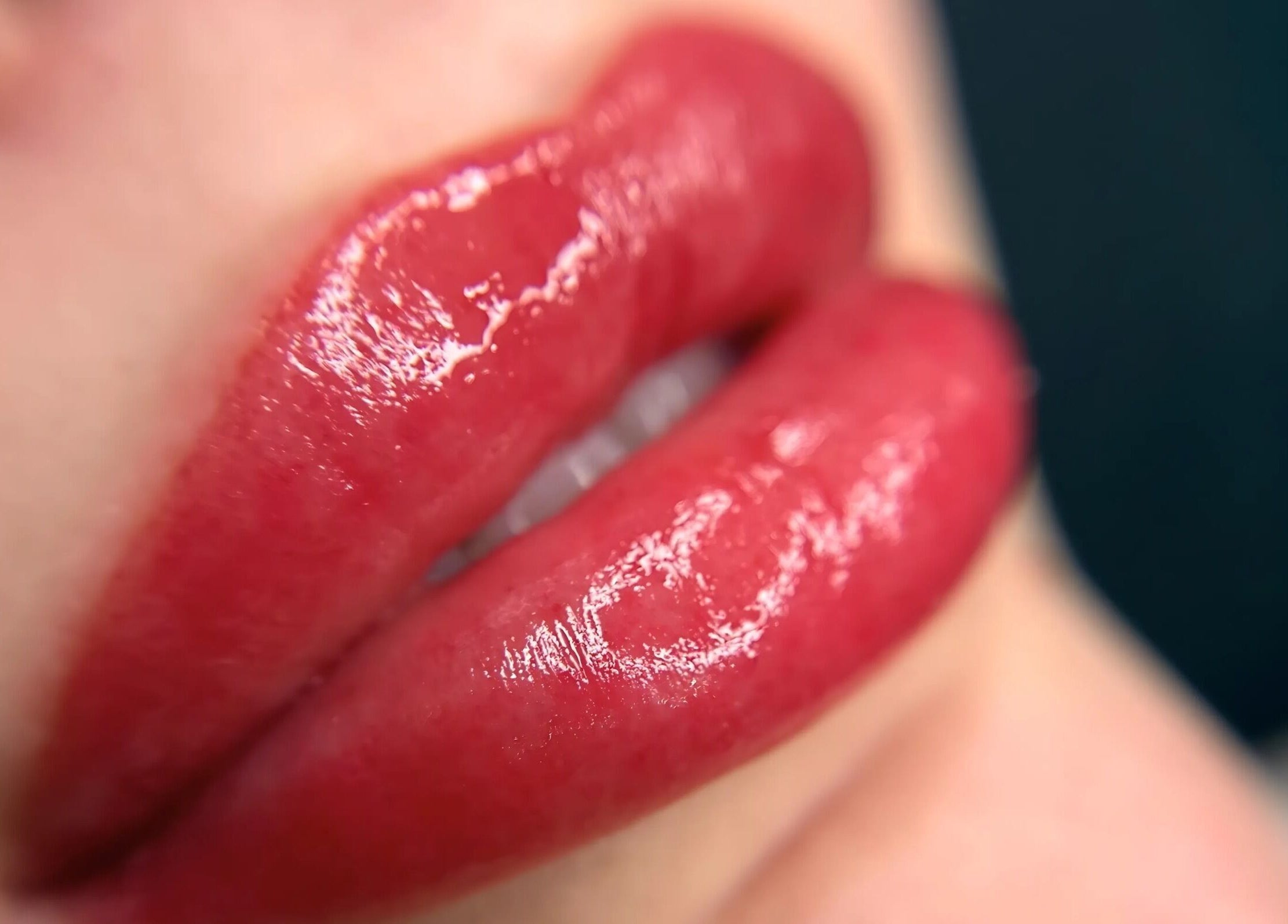 Close-up of glossy red lips at Narce, West End, Queensland, AU, showcasing a vibrant beauty treatment.