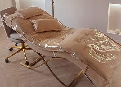 Luxurious treatment bed at Tamoré Beauty, Birmingham, England, GB, showcasing modern comfort and style.