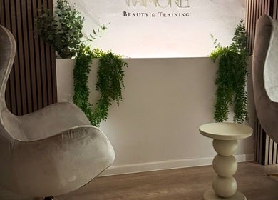 Luxury seating area at Tamoré Beauty, Birmingham, England, GB, with stylish chairs and greenery.