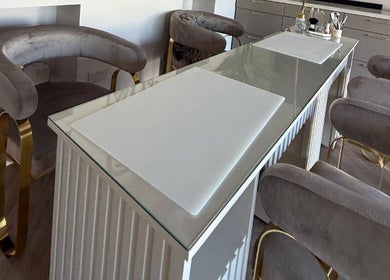 Luxurious manicure station at Tamoré Beauty, Birmingham, England, GB, featuring plush seating and chic design.