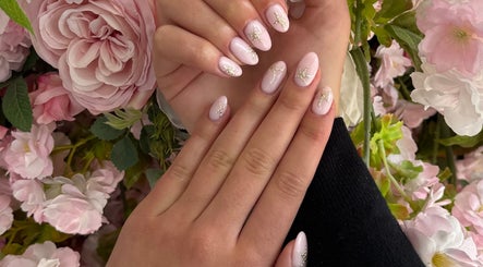 Beautiful floral nail art displayed at Esel Beauty, Enfield, England, GB showcasing intricate pink designs.