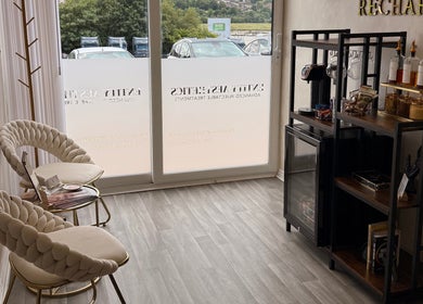 Elegant seating area at Entity Aesthetics, Rochester, England, GB with plush chairs and refreshment bar.