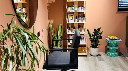 Stylish salon setup at Hoipolloi Studio in Winchester, England, GB, featuring a chair and product display.