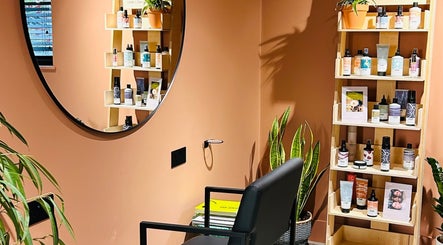 Elegant beauty corner at Hoipolloi Studio in Winchester, England, GB featuring shelves with products and a mirror.