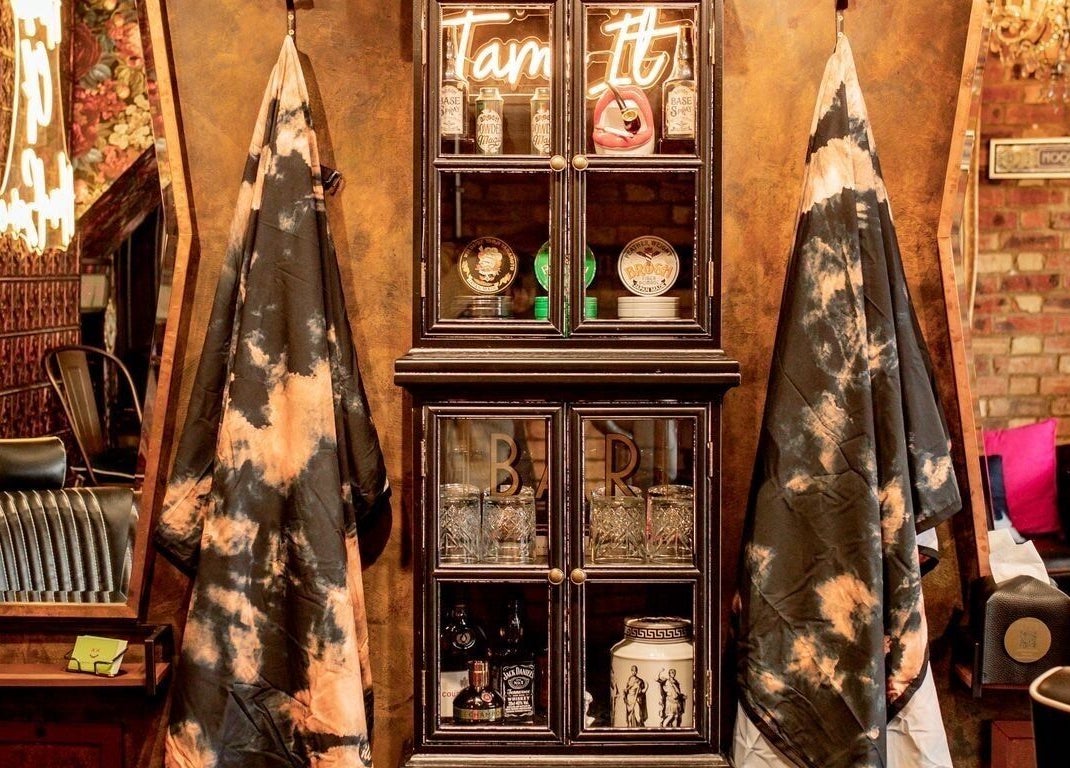 Elegant vintage styling section at J wavey, Kempston, England, GB with mirrors and plush chairs.