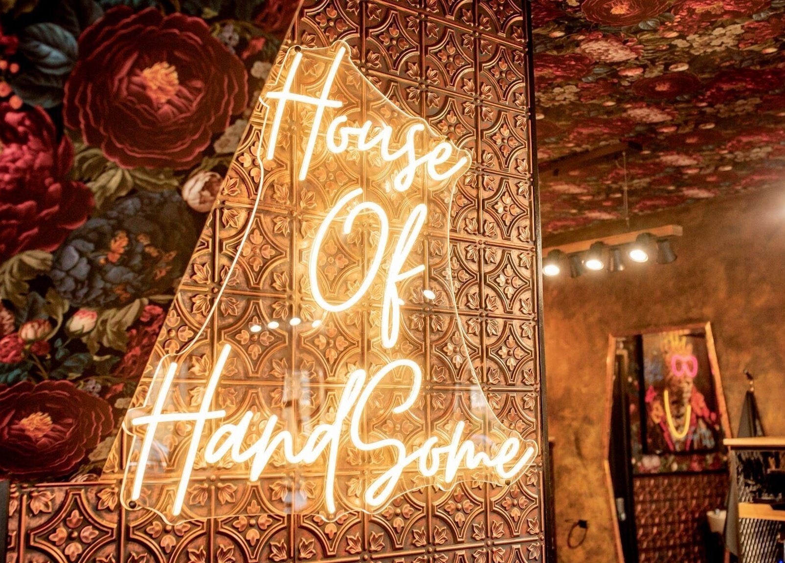 Warm ambiance at J wavey in Kempston, England, GB with decorative floral walls and neon lighting.