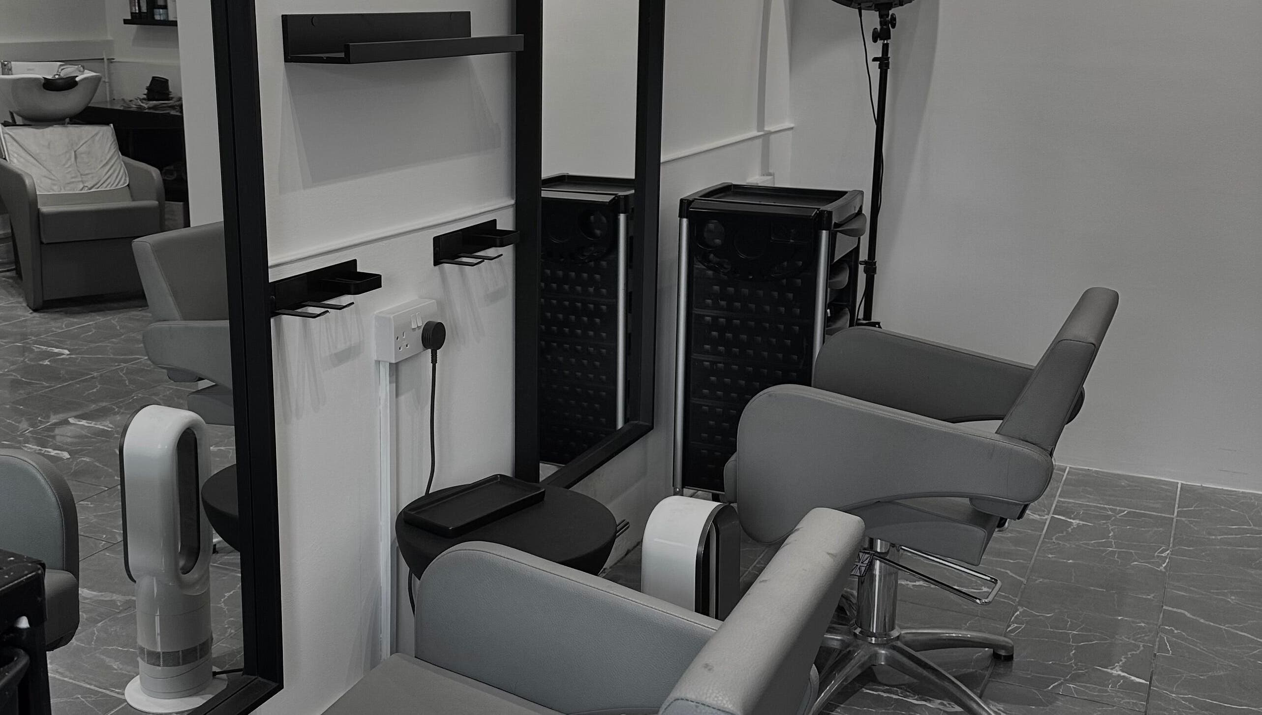 Modern salon chairs and mirrors at Hair by Tyler Alexandra in Basildon, England, GB provide a chic, welcoming space.