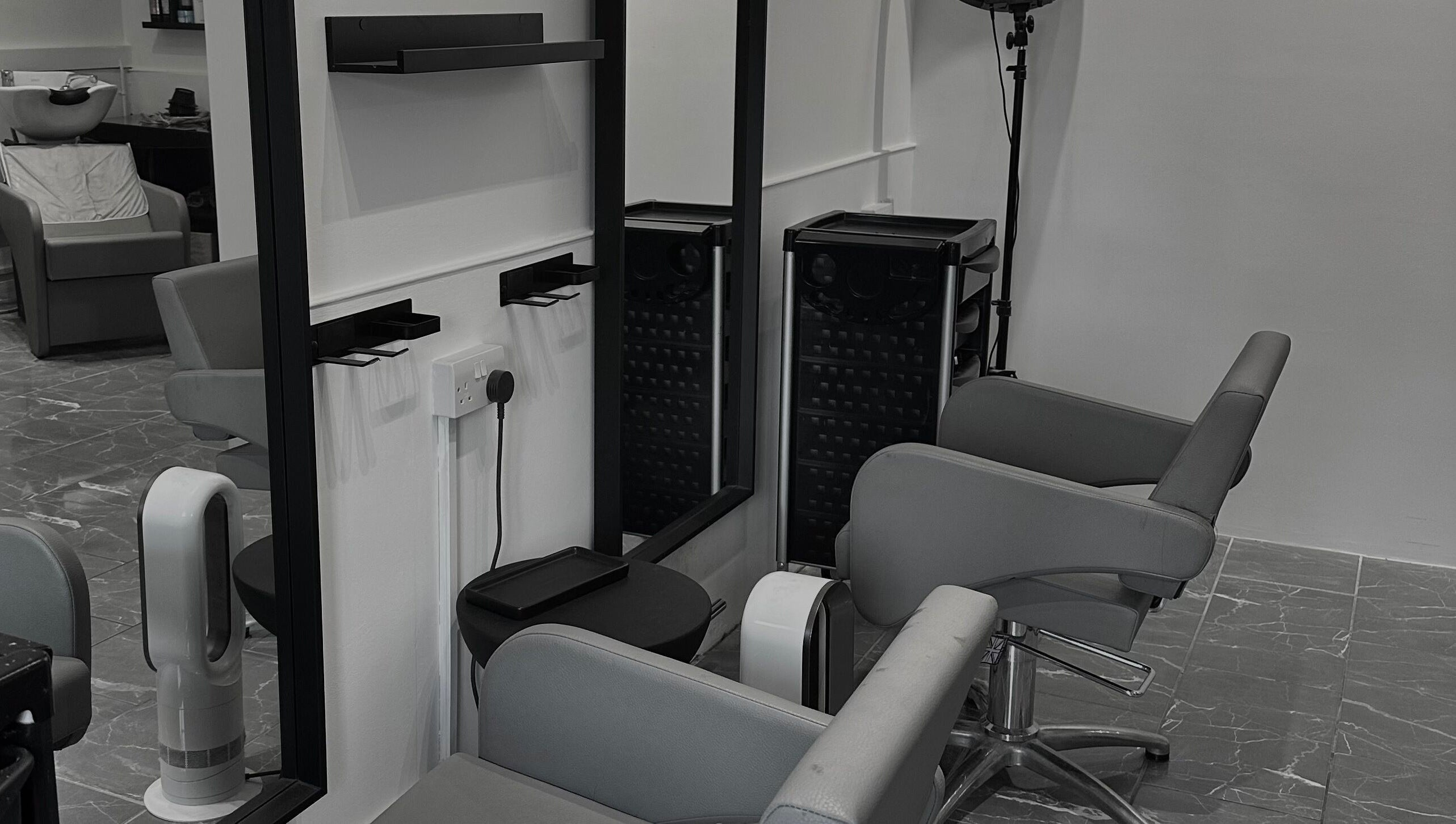 Modern salon chairs and mirrors at Hair by Tyler Alexandra in Basildon, England, GB provide a chic, welcoming space.