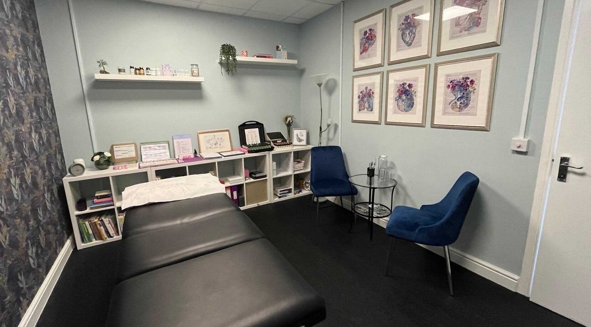 Cozy therapy room at The Bristol Kinesiologist in Emersons Green, England, GB. Modern decor with seating and treatment bed.