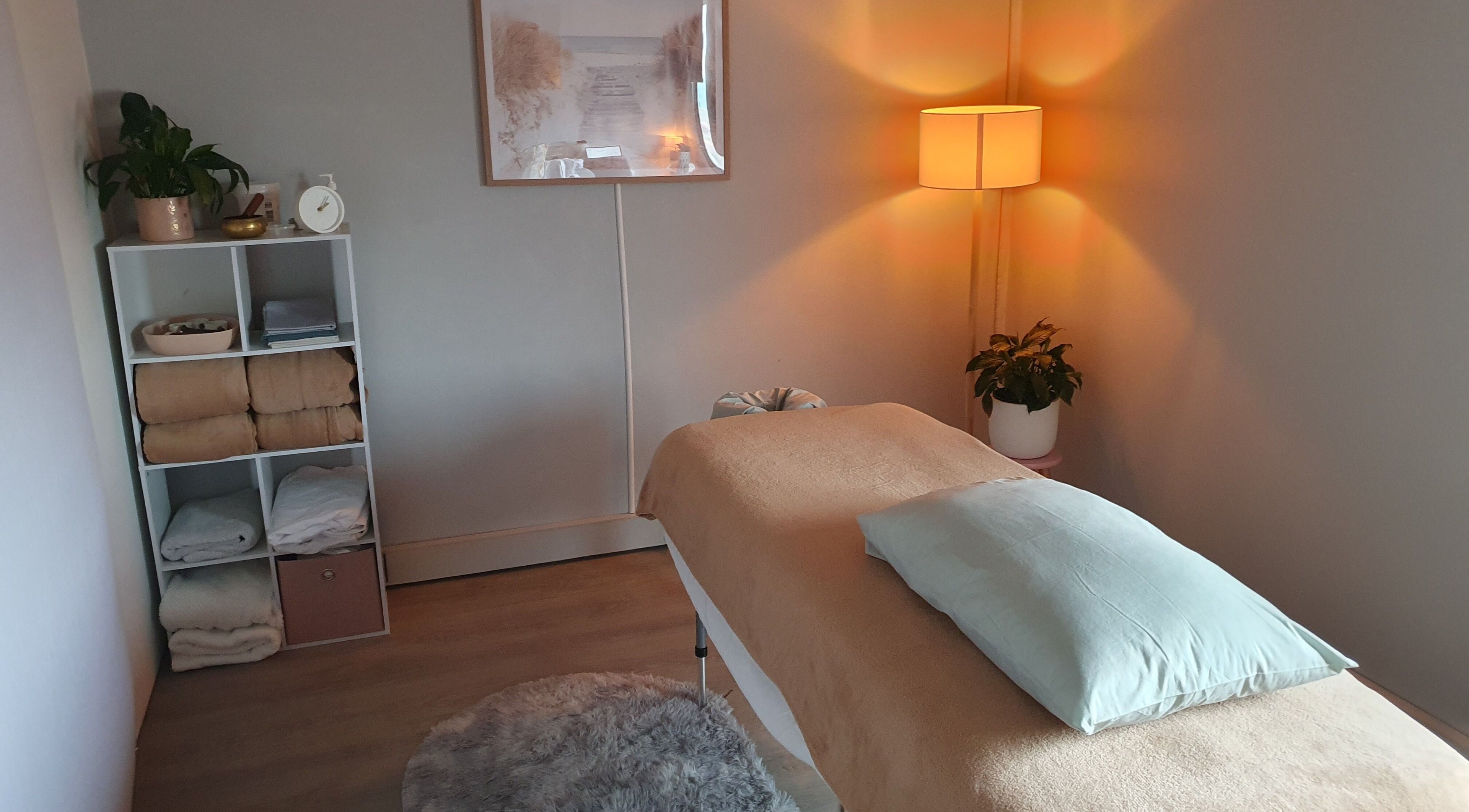 Cozy massage room at Harmony Hands, Eaton, Western Australia, AU with soft lighting and plush bedding.
