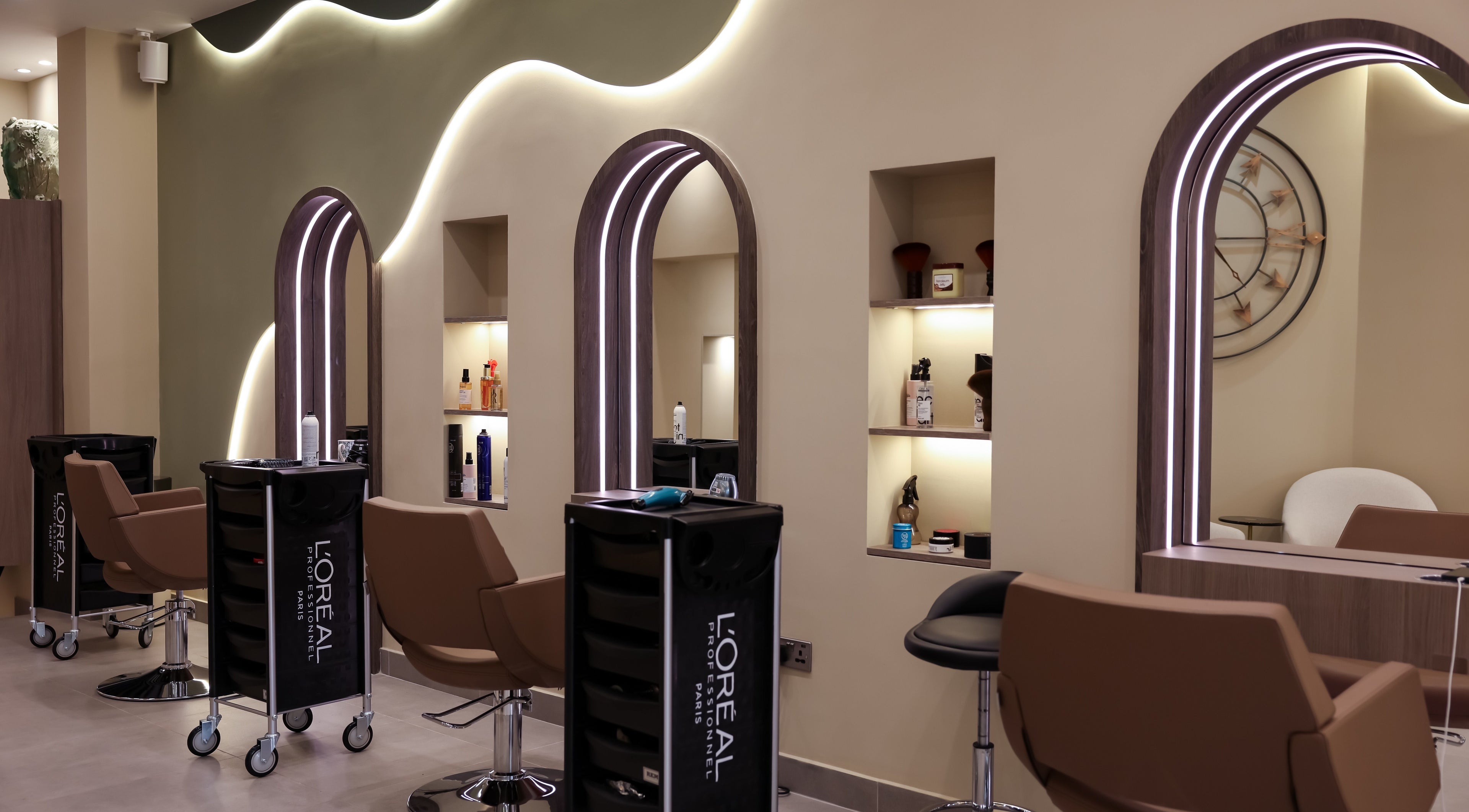 Chic interior of Marnis Salon in London, England, GB, featuring stylish chairs and backlit mirrors.