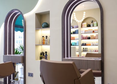 Elegant styling chairs and backlit mirrors at Marnis Salon, London, England, GB.
