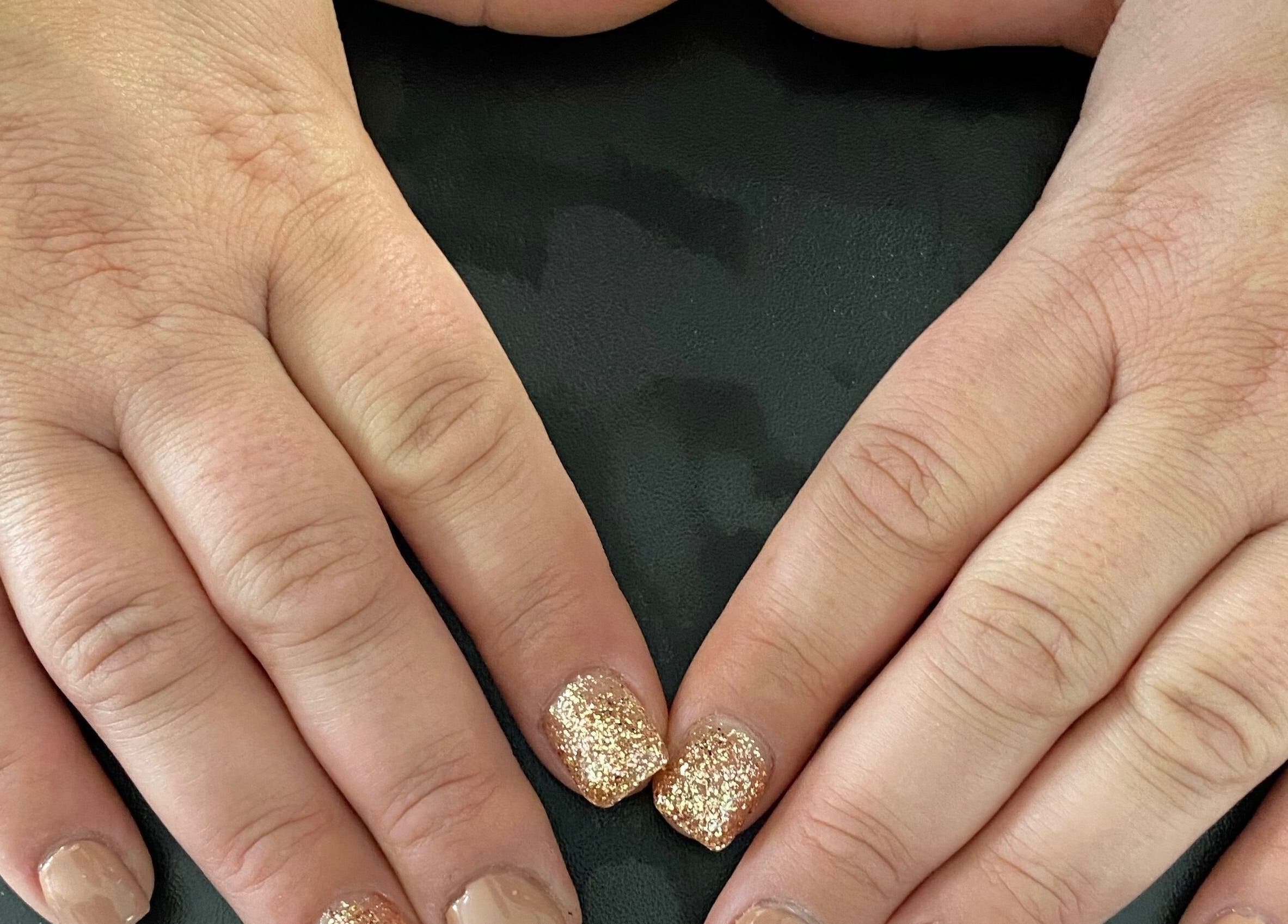 Sparkling gold nails showcased at Flawless Finish Salon, Otisville, New York, US.