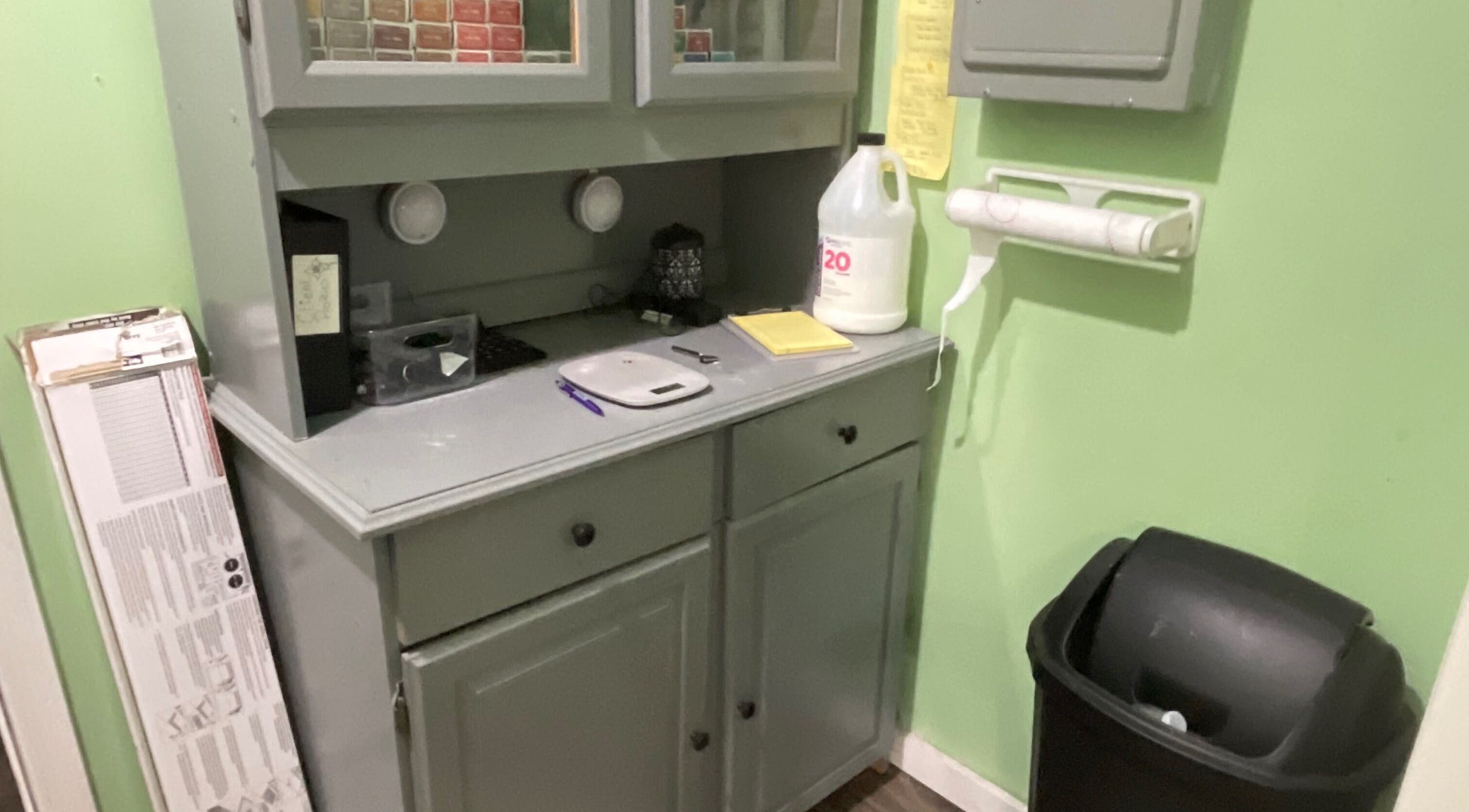 Storage nook at Flawless Finish Salon in Otisville, New York, US, featuring a stylish cabinet and essentials.