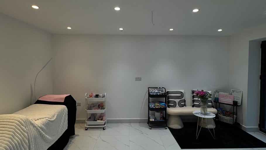 Modern treatment room at TopLash Parlour, Rainham, England. Features chic decor and comfy seating.