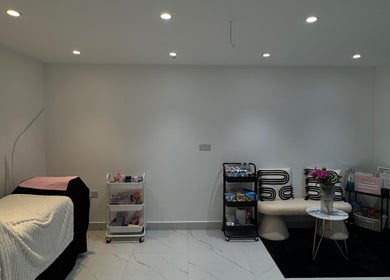Modern treatment room at TopLash Parlour, Rainham, England. Features chic decor and comfy seating.