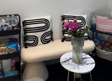 Cozy seating area with snacks at TopLash Parlour, Rainham, England, GB, showcasing comfort and style.