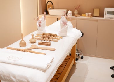 Relaxing spa room at Reed Women Beauty And Fitness Center, Abu Dhabi, AE with wooden massage tools and soft towels.